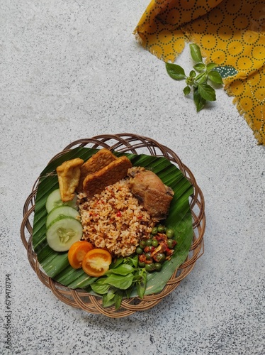 nasi tutug onom with dish and salad  photo