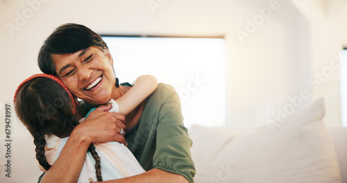 Grandmother, grandchild and smile in hug, love and bonding in retirement, care and relaxing. Happy mexican people, sofa and welcome in visit, greeting and embrace on couch, gratitude and affection photo