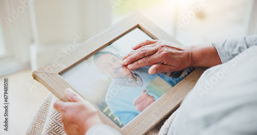 Senior woman, grief and picture of husband on lap, hands and sad of love loss in retirement. Elderly person, alone and dear memory of beloved with anxiety, mental health and lonely bereaved in house photo