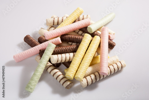 a bunch of multi-colored waffle rolls on a white background