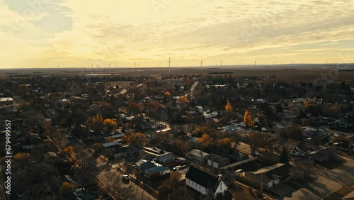 Drone footage of the quiet streets of Assiniboia Canalta, Saskatchewan, Canada, featuring a backdrop of wind turbines. photo