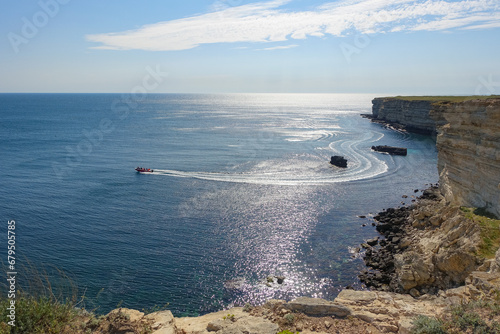 Cape Tarkhankut on the Crimean peninsula. The rocky coast of the Dzhangul Reserve in the Crimea. The Black Sea. Turquoise sea water. Rocks and grottoes of Cape Tarkhankut. photo