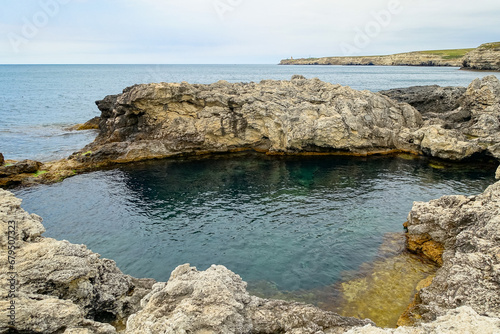 Cape Tarkhankut on the Crimean peninsula. The rocky coast of the Dzhangul Reserve in the Crimea. A sunny summer day. The Black Sea. Turquoise sea water. photo