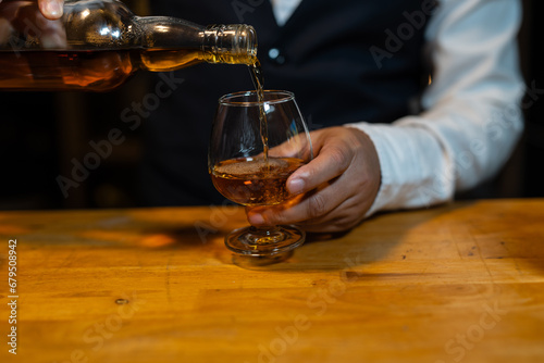 Businessman wearing a suit whiskey glass of liquor.