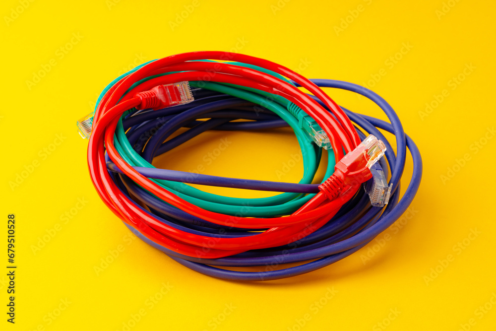 Network cable on yellow background studio shot Network cable on yellow background studio shot