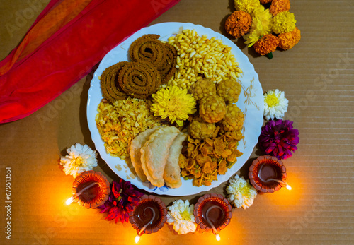 diwali snacks or diwali faral chakli, chiwda, and ladoo decorated in plate  for Diwali festival  photo