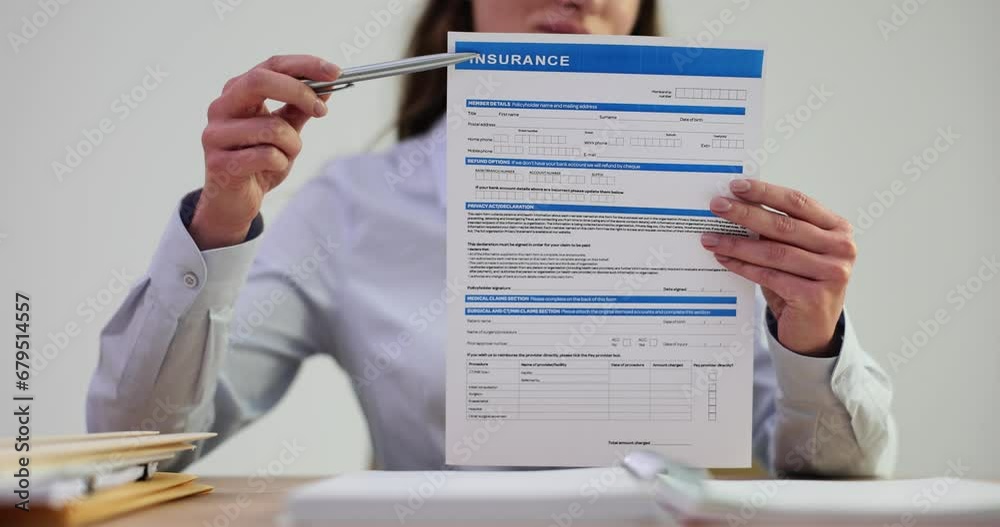 Woman agent holding insurance application form Woman agent holding insurance application form
