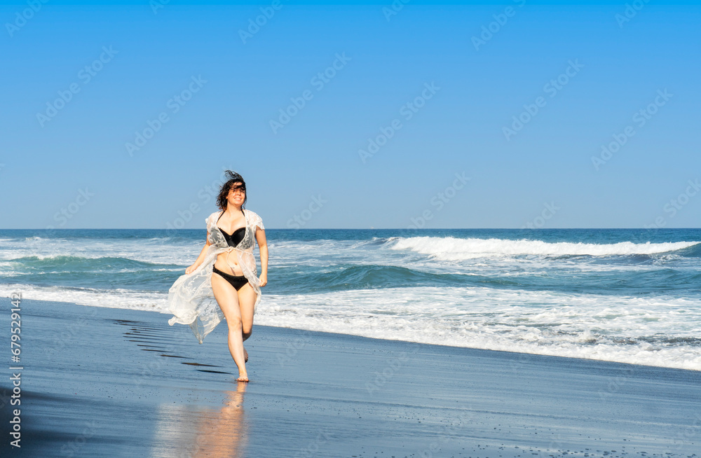 Young woman running on the beach Young woman running on the beach