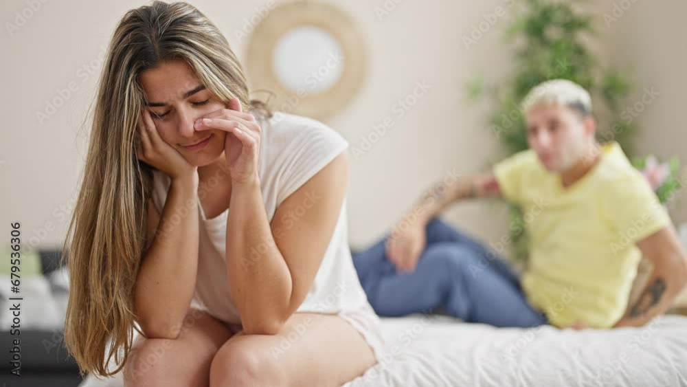 Beautiful couple hugging each other sitting on bed supporting at bedroom Beautiful couple hugging each other sitting on bed supporting at bedroom