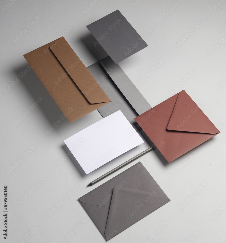 Floating envelopes and card on gray background with shadow. Minimalism, modern business still life, creative layout Floating envelopes and card on gray background with shadow. Minimalism, modern business still life, creative layout
