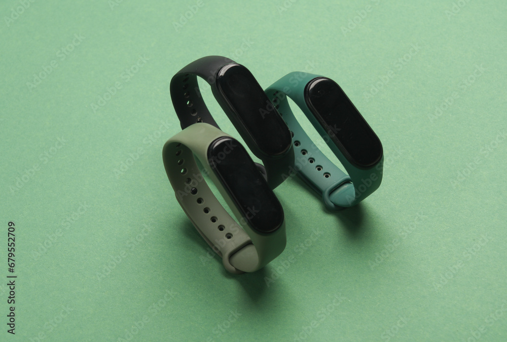 Three smart bracelets on a green background Three smart bracelets on a green background