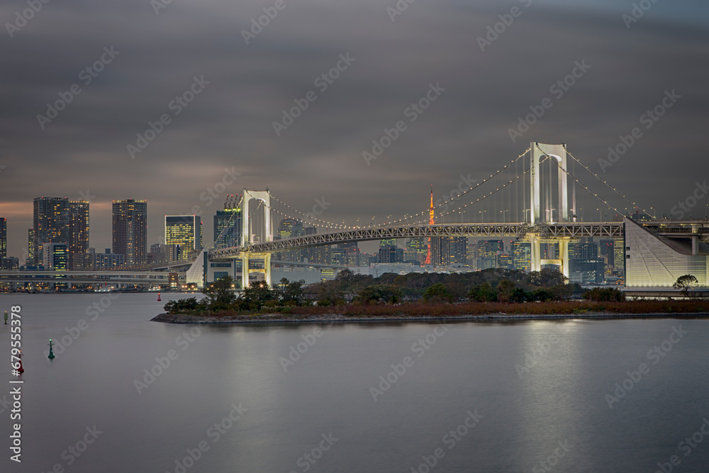 Japan Travel Destinations. Closeup View of Rainbow Bridge in Odaiba Island in Tokyo At Twilight with Line of Skyscrapers
