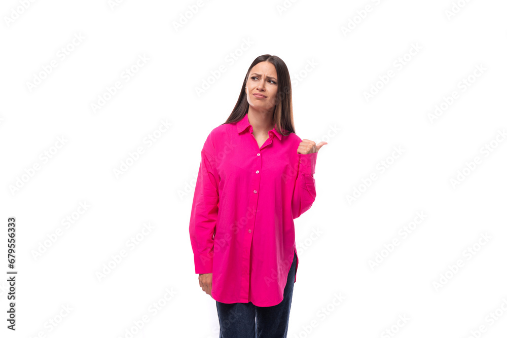 pretty young brunette lady dressed in a bright pink shirt points with her hands in a row of advertising pretty young brunette lady dressed in a bright pink shirt points with her hands in a row of advertising