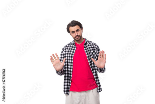 Portrait of a caucasian handsome man with a beard and styled hair stands thoughtfully on a white background with copy space © Ivan Traimak