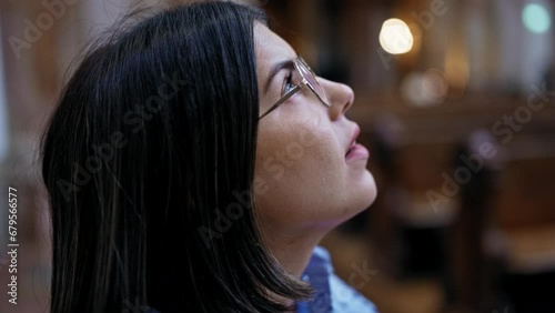 Young beautiful hispanic woman visiting church at St. Karl Borromäus church photo