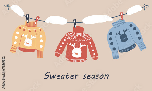Sweaters hang on clothespins, a snowdrift on a rope. The season of winter sweaters, warmth and comfort. Warm and cozy clothes