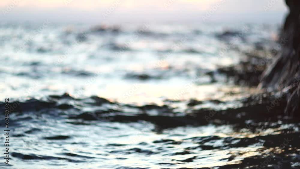Golden sunset on the beach. Foamy waves rolling towards golden sand beach under low warm sun light. Slow motion. Nobody. Holiday recreation concept. Abstract nautical summer ocean sunset nature. Golden sunset on the beach. Foamy waves rolling towards golden sand beach under low warm sun light. Slow motion. Nobody. Holiday recreation concept. Abstract nautical summer ocean sunset nature.