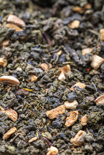 Dried natural large tea leaves close up. Chinese tea Tie Guan Yin, with the addition of orange pieces.