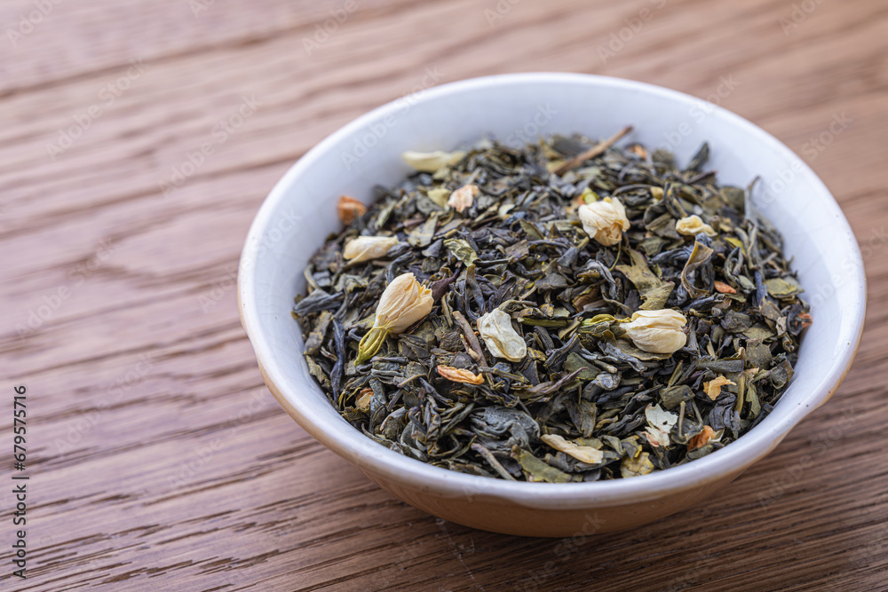 Dried natural large tea leaves close up. Chinese jasmine tea Hua Zhu Cha. Dried natural large tea leaves close up. Chinese jasmine tea Hua Zhu Cha.