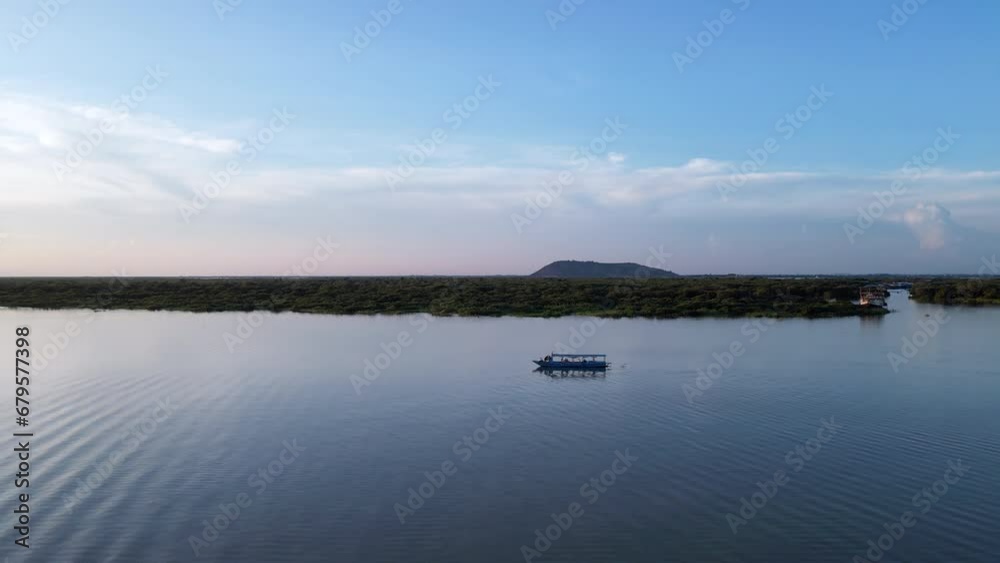 Junk Boat on Lake in Cambodia at Sundown Drone Rise Junk Boat on Lake in Cambodia at Sundown Drone Rise