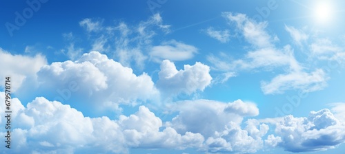 Serene blue sky with fluffy white clouds   perfect natural background for summer concepts