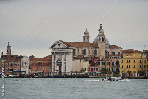Traditional Venetian landscape. Old christian catholic church at the waterfront of Guidecca canal. Venice - 6 May, 2019
