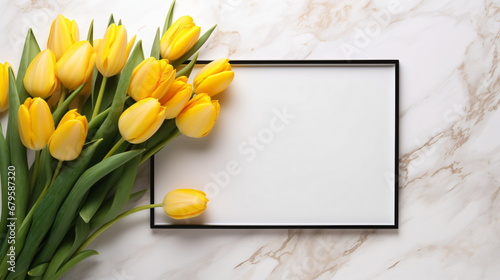 Golden color photo frame on a marble background with yellow tulip flowers, copy space, used for wedding photos