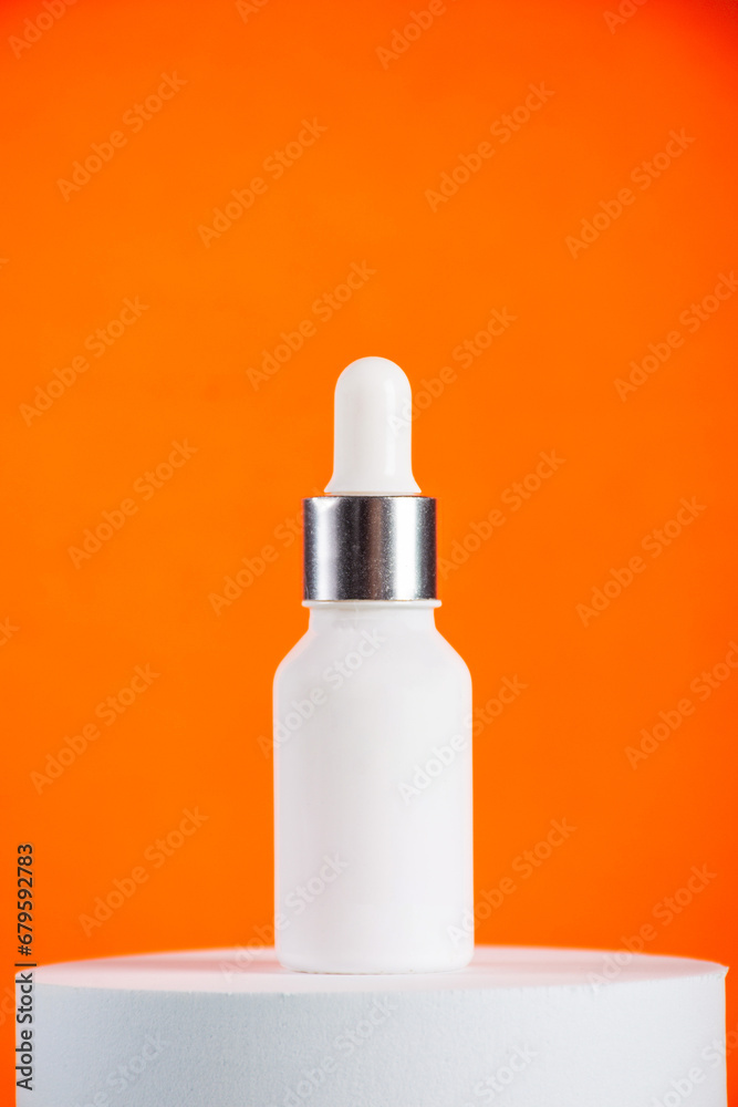 Plastic white tube for cream or lotion. Skin care or sunscreen cosmetic with stylish props on orange background Plastic white tube for cream or lotion. Skin care or sunscreen cosmetic with stylish props on orange background