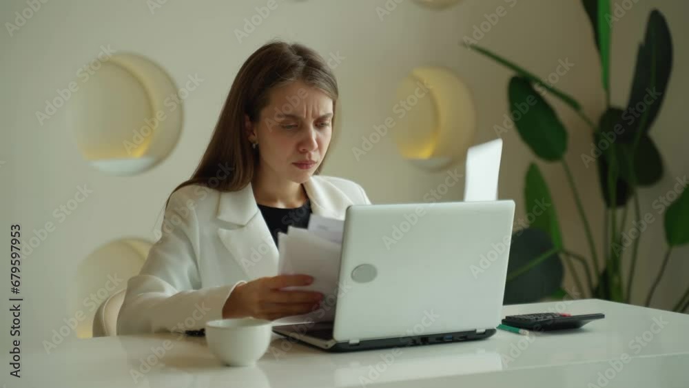 An angry businesswoman or office worker screams, screams and throws papers around her office desk An angry businesswoman or office worker screams, screams and throws papers around her office desk