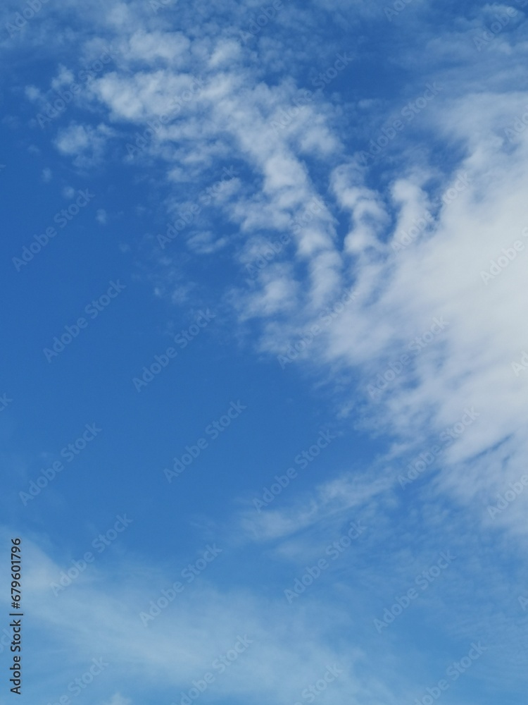 Full frame of pretty blue sky with unusual scudding cloud formation Full frame of pretty blue sky with unusual scudding cloud formation