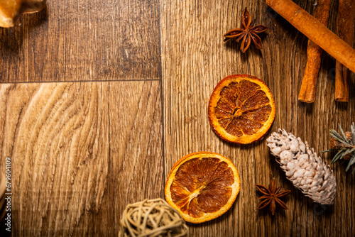 dried oranges with cinnamon on a wooden background among Christmas decorations