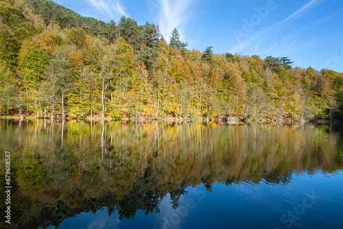 Yedigöller or Seven Lakes National Park is in Turkey.
Reflection of a lake with trees and blue sky in autumn colors. Yedigöller, Bolu.
Yedigöller in autumn. Bolu, Türkiye.