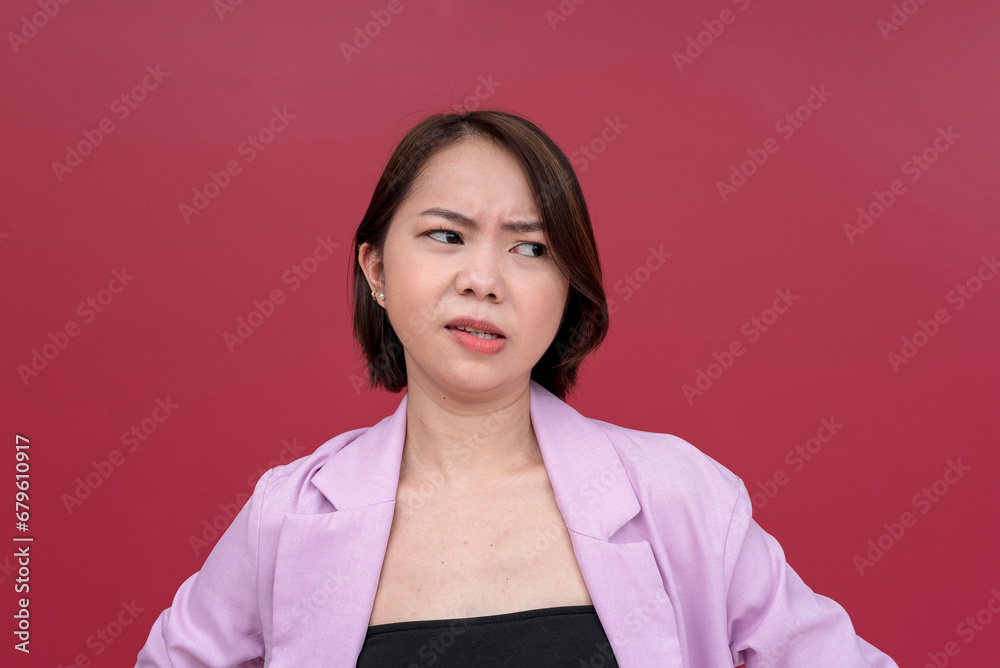 A disgusted young asian woman in her mid 20s looking repulsed at ...