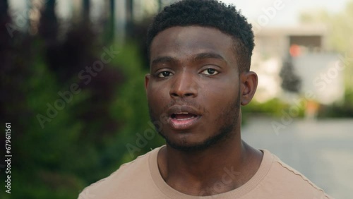 Close up amazed wonder male face African American man biracial shocked guy open mouth shock amazing news surprise face expression astonishment excited say wow in city outdoors win achievement success photo