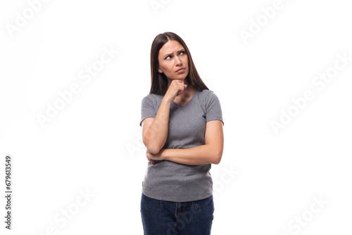 young well-groomed brunette woman in a gray t-shirt with a mock-up for an identity on a white background with copy space © Ivan Traimak