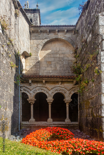 A beautiful and flowery interior garden in the patio of the Collegiate Church of Sar, in Santiago de Compostela, in the background you can see a series of semicircular arch windows
