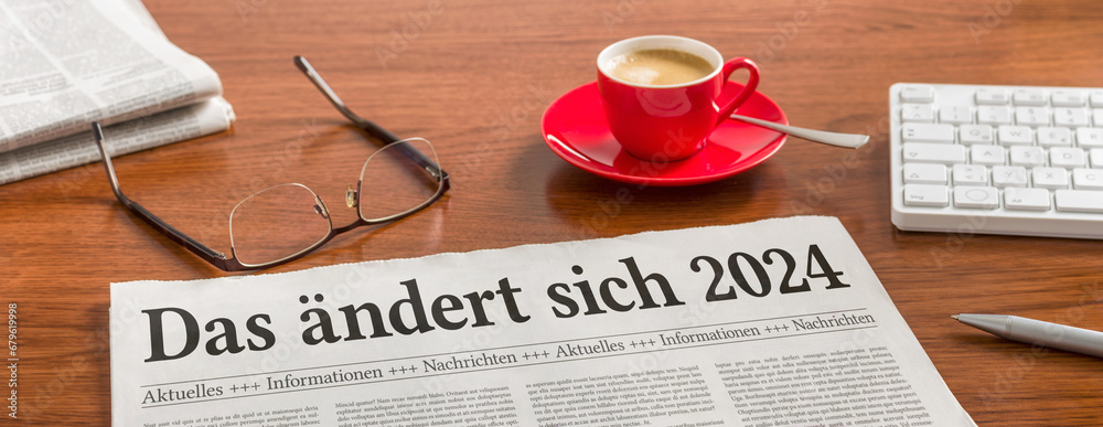 Zeitung auf Schreibtisch - Das ändert sich 2024 - obrazy, fototapety, plakaty 