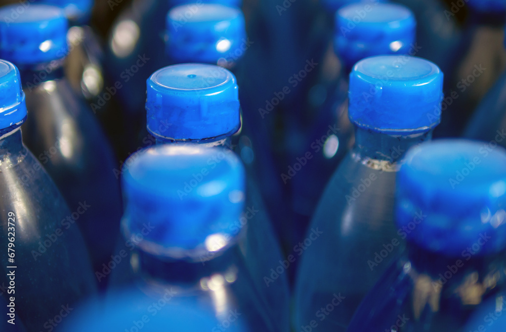 Close-up of Large Number of Packed Blue Bottled Drinking Water with Blue Caps.drinking water bottle background Close-up of Large Number of Packed Blue Bottled Drinking Water with Blue Caps.drinking water bottle background