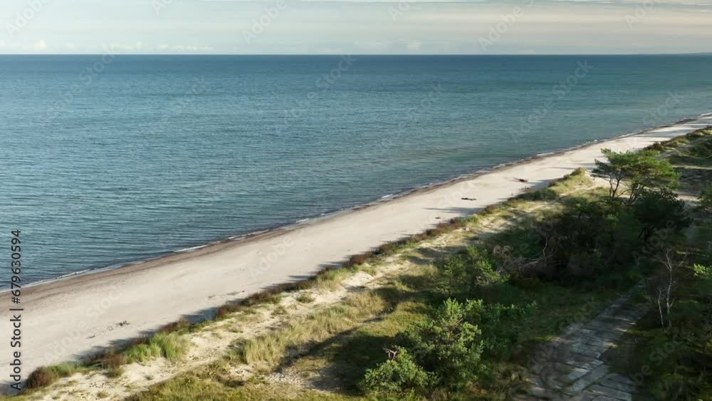 Ustka's seaside beach during autumn, showcasing a tranquil coastal scene. Ustka's seaside beach during autumn, showcasing a tranquil coastal scene.