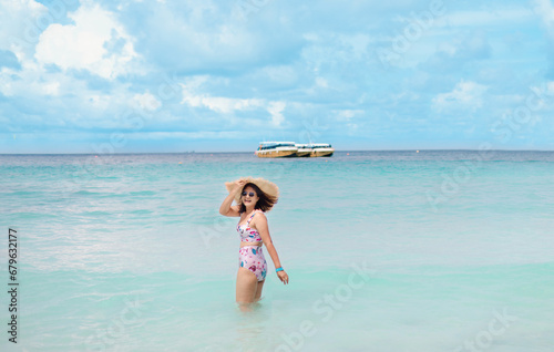 Woman playing in water at beach on sunny day © sommai