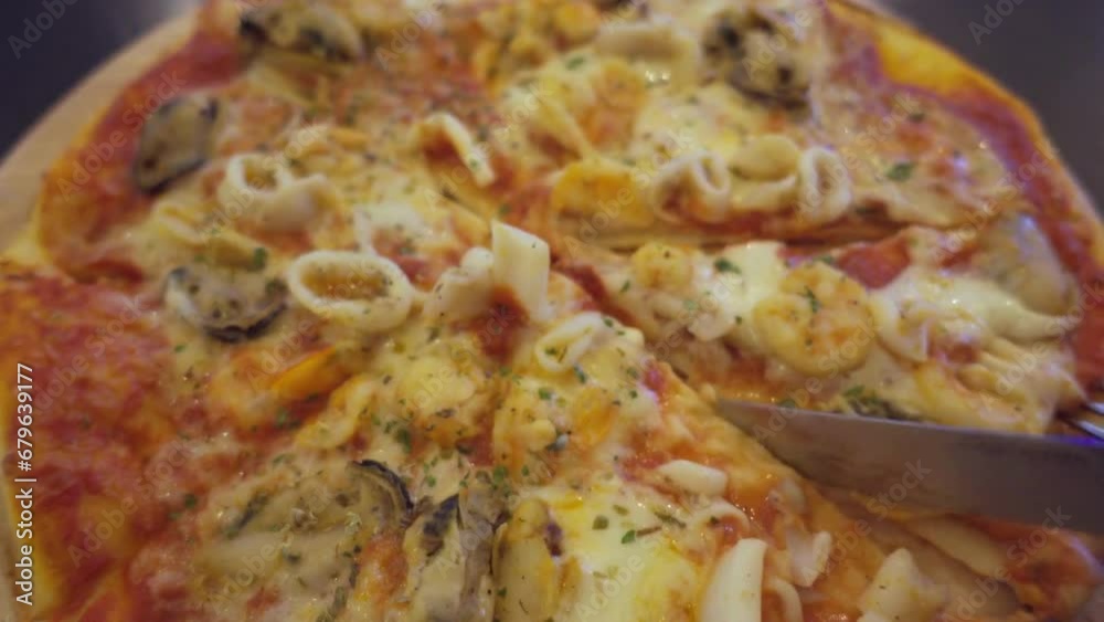Close up of Well Baked Pizza with Salami, Fragrant Herbs, Melted Cheese. Fresh Close up of Well Baked Pizza with Salami, Fragrant Herbs, Melted Cheese. Fresh