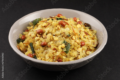 Poha Chivda or Chiwada. Diwali special savory snack, made out of Flattened rice, fried peanuts, curry leaves and some spices. Traditional Indian Diwali Snacks. photo