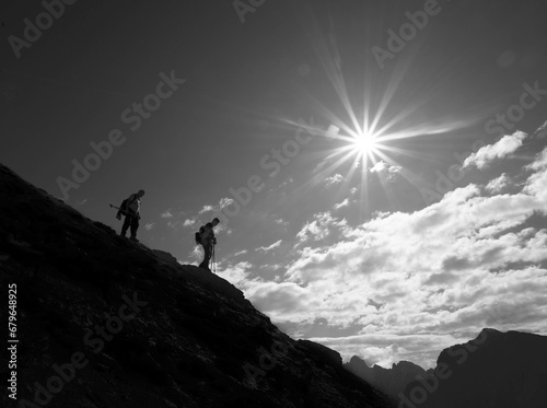 silhouette of a person on the top of mountain