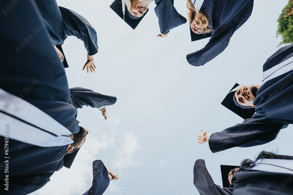 Achievement unlocked. Graduates in their caps and gowns stand together in a circle, celebrating their success and creating university memories for life. Achievement unlocked. Graduates in their caps and gowns stand together in a circle, celebrating their success and creating university memories for life.