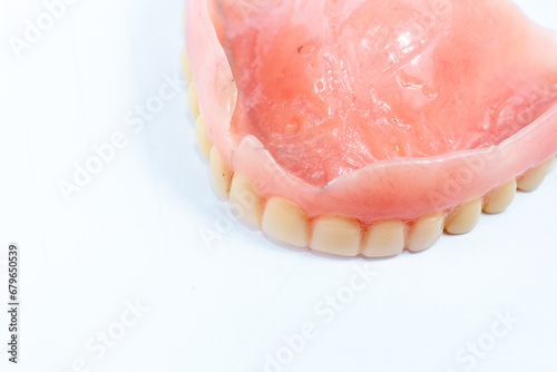 Old denture on a white background.