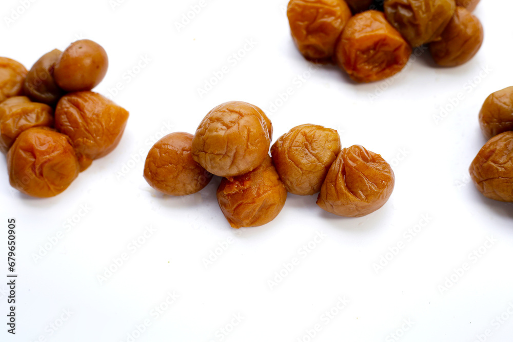 Pickled plums on white background.