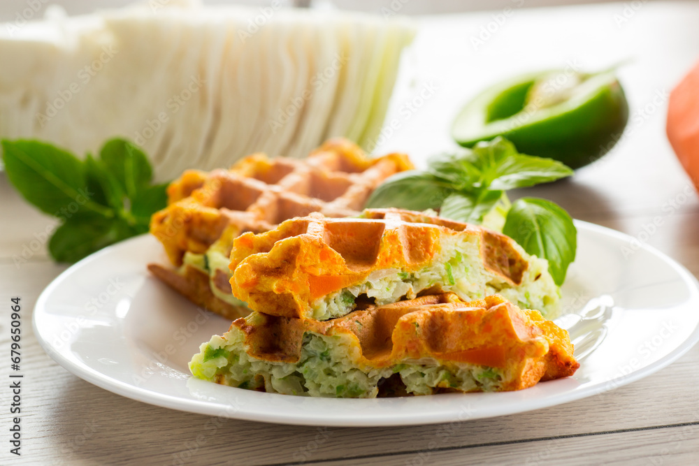 cooked two-color vegetable waffles made from cabbage and carrots. - obrazy, fototapety, plakaty 