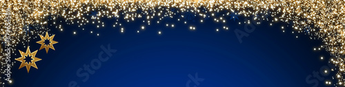 Christmas background with blurred lights and golden stars isolated on blue.