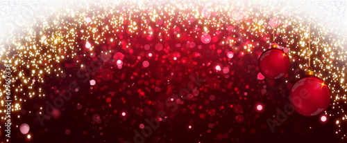 Christmas balls on red blurred bokeh background .