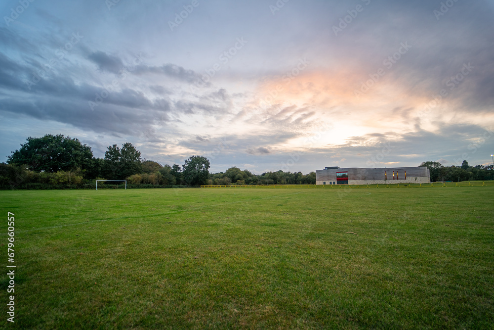 Large empty camping area in England during sunset - obrazy, fototapety, plakaty 